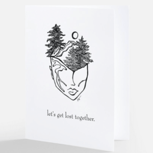 Image of greeting card called a love note that says let's get lost together with an abstract line drawing of a face with mountains and trees growing out of it.